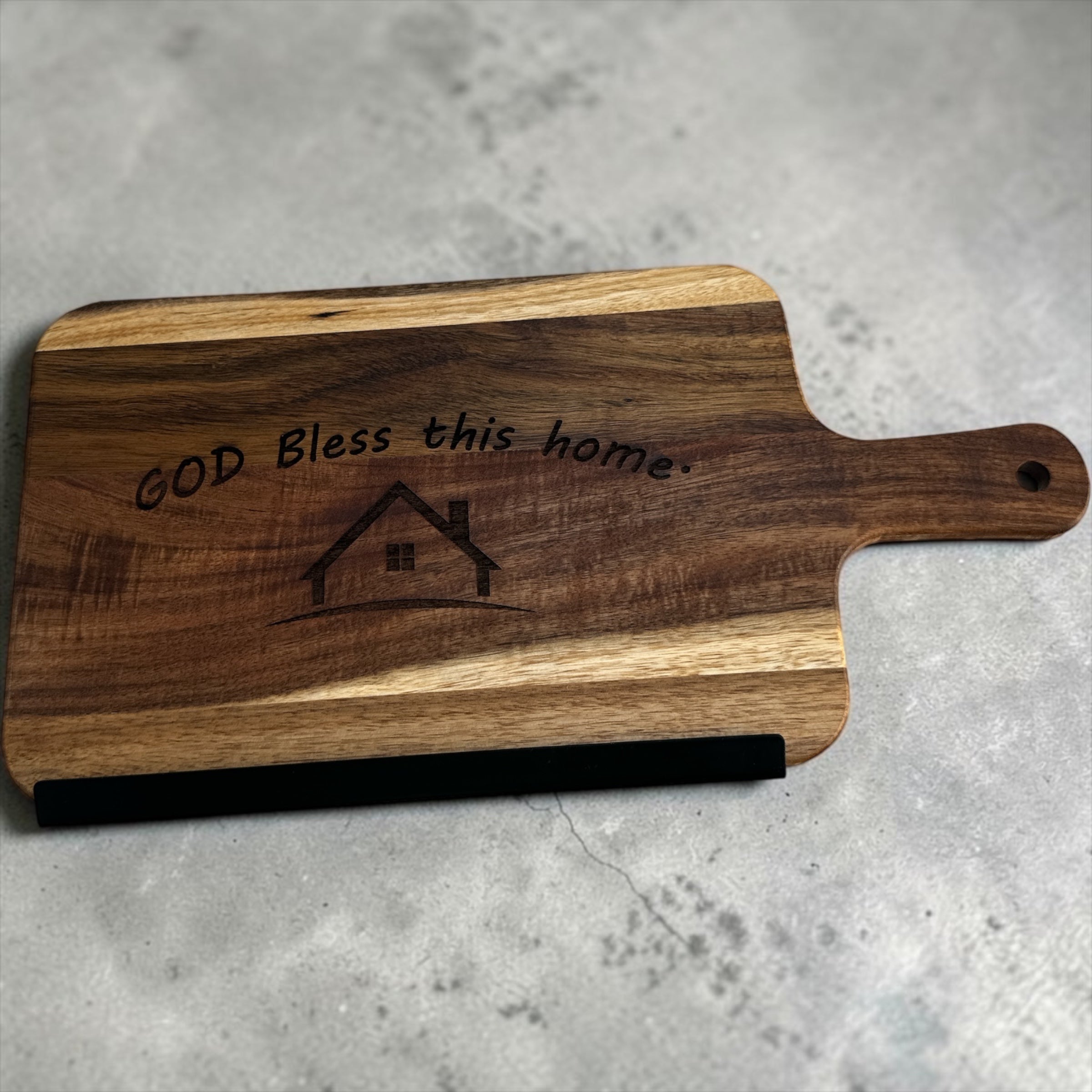 8"x15" God Bless This Home cutting board with handle.